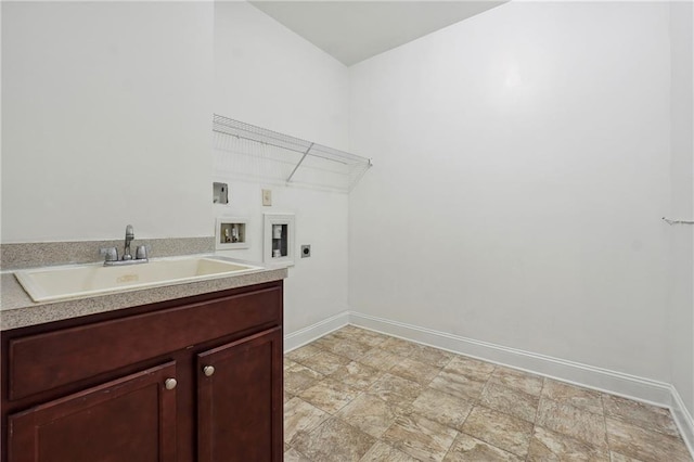 washroom with electric dryer hookup, baseboards, washer hookup, and a sink