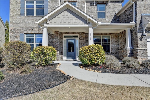 view of exterior entry with brick siding