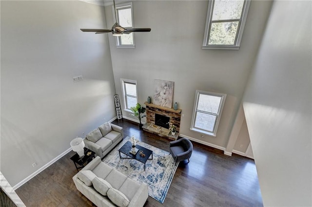 living room featuring a healthy amount of sunlight, a fireplace, and wood finished floors