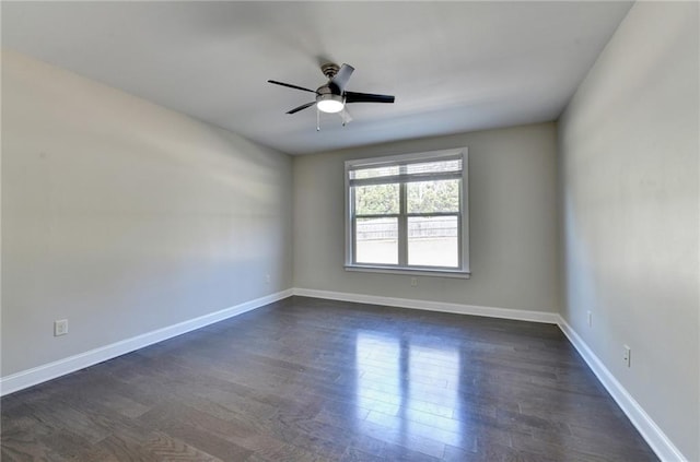 unfurnished room featuring a ceiling fan, dark wood-type flooring, and baseboards