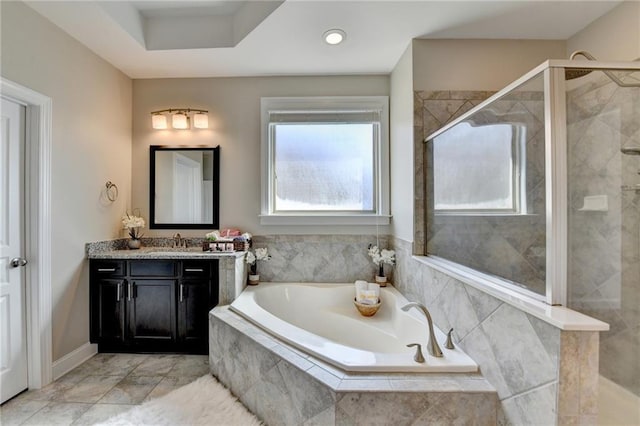 bathroom with vanity, a bath, and a shower stall