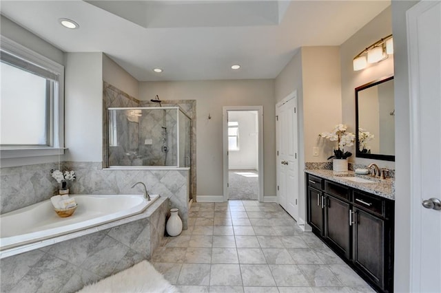 bathroom featuring a garden tub, recessed lighting, a shower stall, baseboards, and vanity