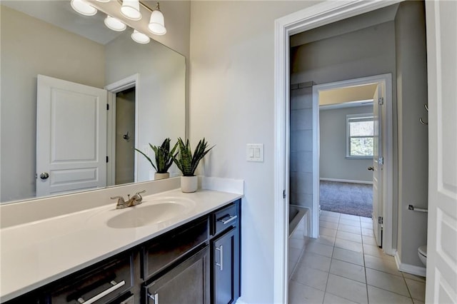 full bath featuring vanity, toilet, baseboards, and tile patterned flooring