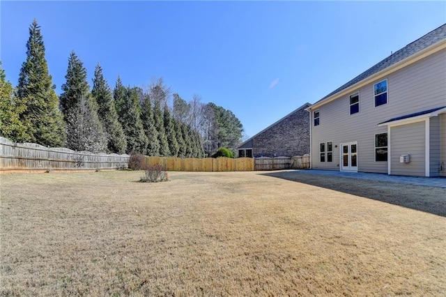 view of yard featuring french doors and fence private yard