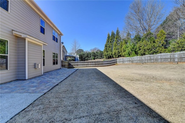 view of yard featuring a patio and a fenced backyard