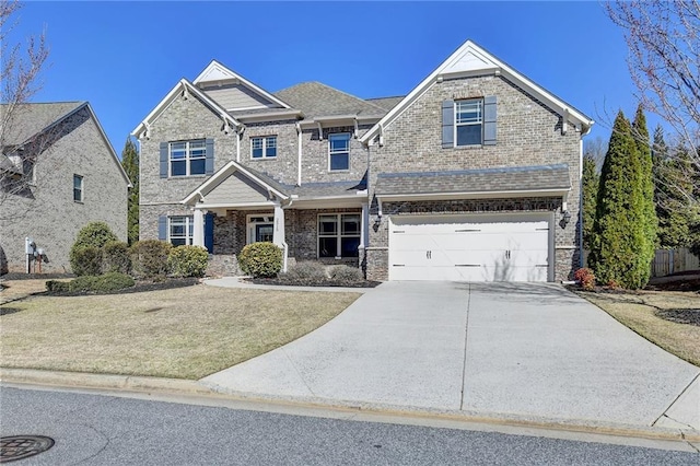 craftsman inspired home featuring concrete driveway, an attached garage, brick siding, and roof with shingles