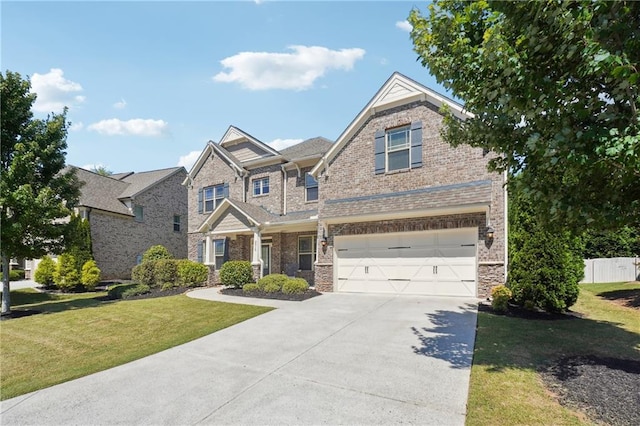 craftsman house featuring brick siding, fence, concrete driveway, a front yard, and a garage