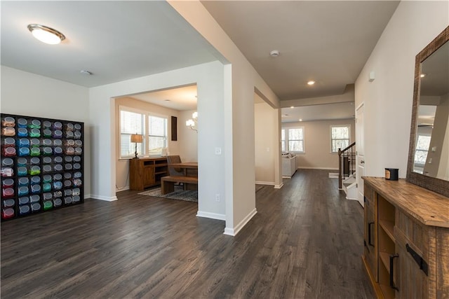 1076 Allspice Way, Lawrenceville, GA 30045 - corridor featuring dark wood-type flooring and an inviting chandelier