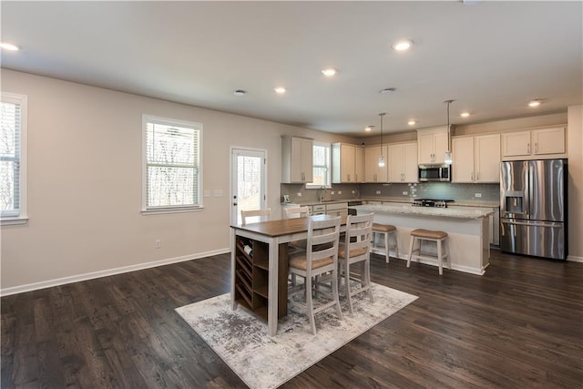 1076 Allspice Way, Lawrenceville, GA 30045 - kitchen with white cabinetry, tasteful backsplash, decorative light fixtures, a kitchen island, and stainless steel appliances
