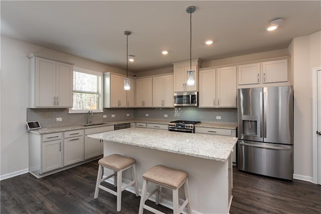 1076 Allspice Way, Lawrenceville, GA 30045 - kitchen with hanging light fixtures, appliances with stainless steel finishes, a kitchen island, light stone countertops, and backsplash