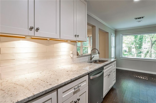 kitchen featuring decorative backsplash, stainless steel dishwasher, ornamental molding, a sink, and light stone countertops