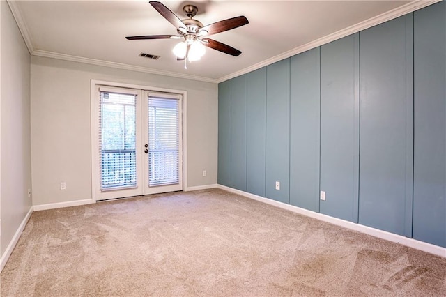 carpeted empty room featuring ceiling fan, visible vents, baseboards, french doors, and crown molding