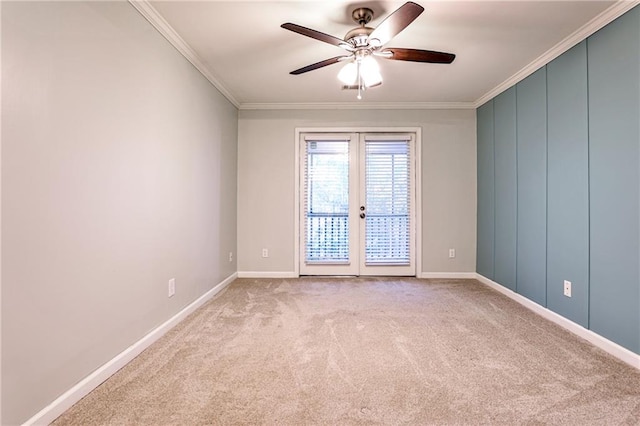 carpeted empty room with ceiling fan, french doors, and crown molding