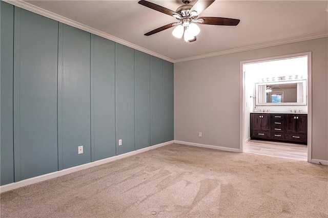 unfurnished bedroom featuring crown molding, light carpet, ceiling fan, and ensuite bathroom