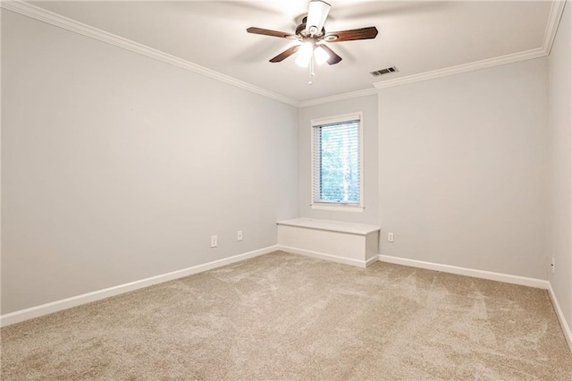 empty room with light carpet, baseboards, visible vents, and crown molding