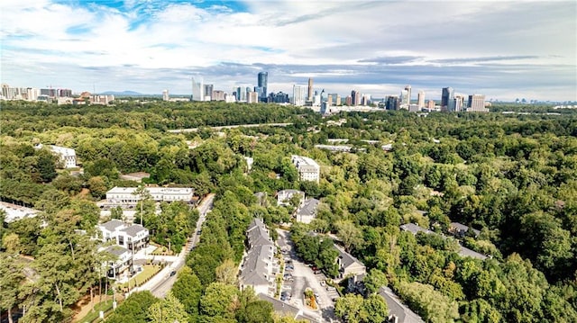 drone / aerial view featuring a forest view and a city view