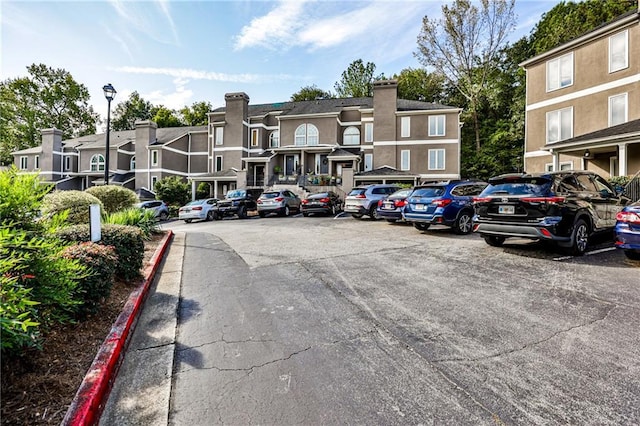 uncovered parking lot with a residential view