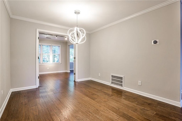 spare room with a chandelier, dark wood-style flooring, visible vents, and crown molding