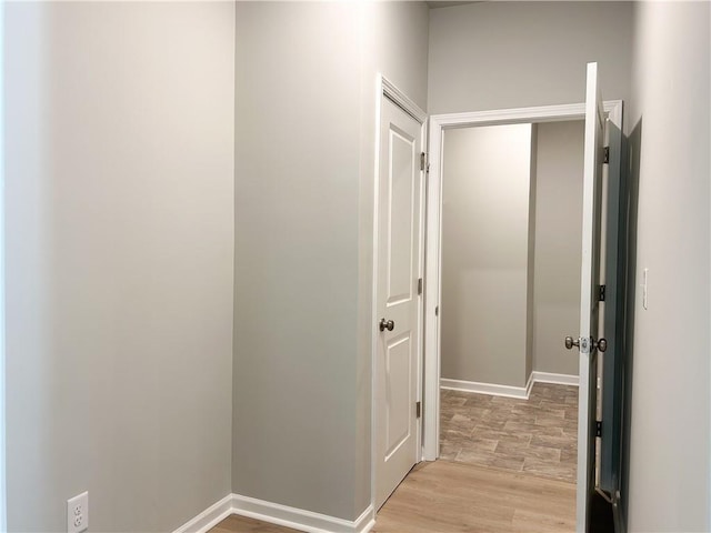 corridor with light wood-type flooring