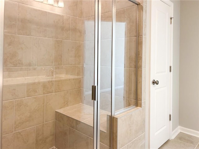 bathroom with tile patterned flooring and a shower with shower door