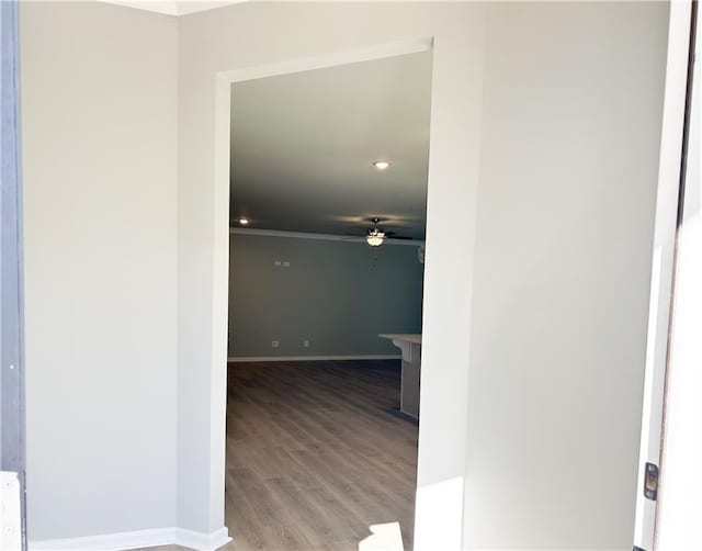 hall with light wood-type flooring and ornamental molding