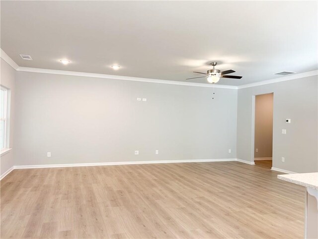 spare room featuring ceiling fan, light hardwood / wood-style floors, and ornamental molding