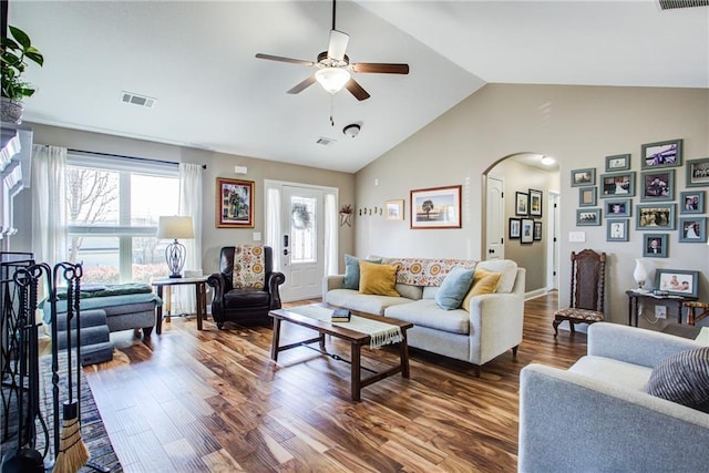 living room with hardwood / wood-style flooring, ceiling fan, and high vaulted ceiling