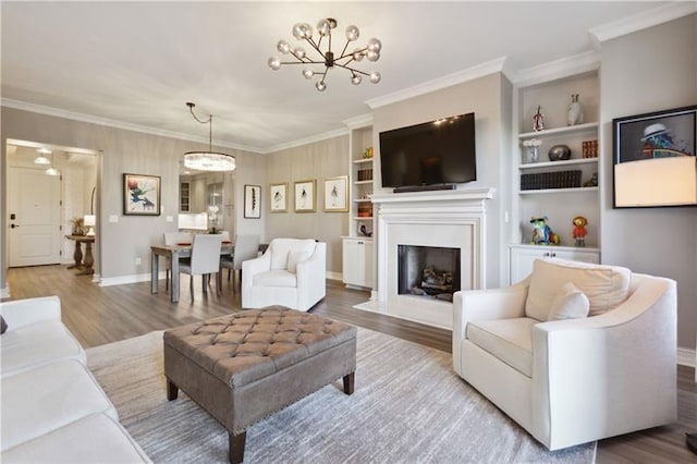 living room with hardwood / wood-style flooring, built in features, and ornamental molding