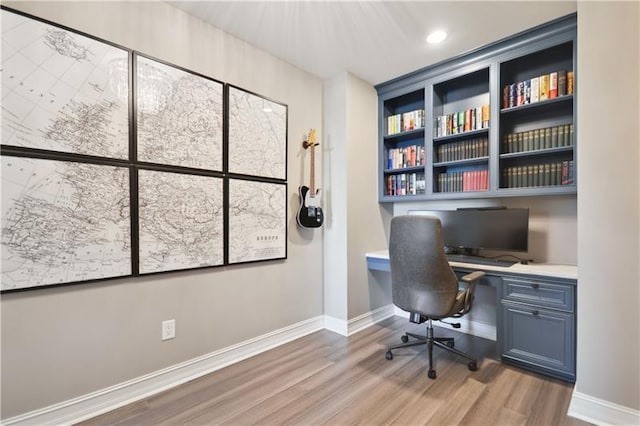 office area with hardwood / wood-style floors and built in desk