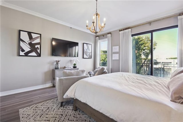 bedroom with hardwood / wood-style flooring, ornamental molding, a chandelier, and access to exterior