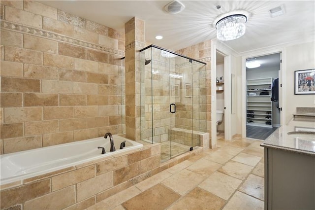 bathroom featuring separate shower and tub, vanity, and a notable chandelier