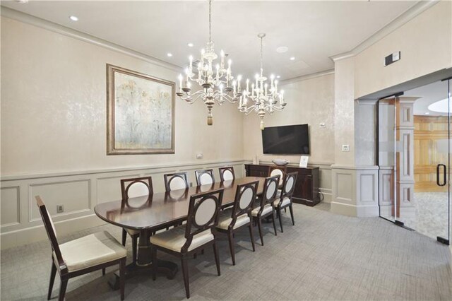 dining room featuring ornamental molding, ornate columns, and light carpet