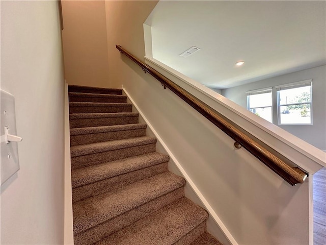 stairs featuring visible vents and baseboards