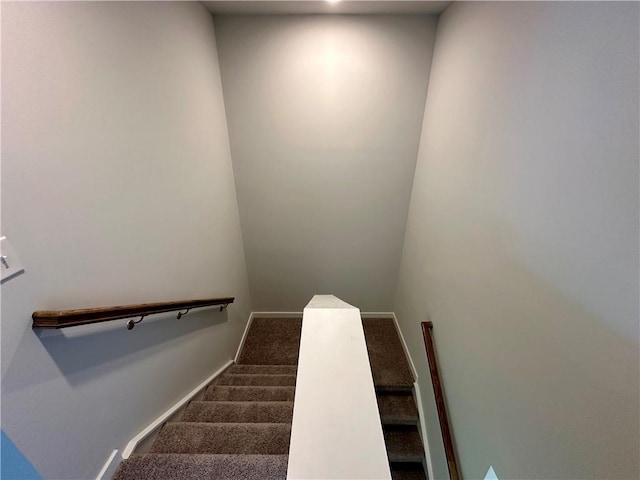 stairs featuring carpet floors and baseboards