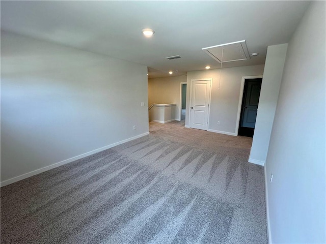 spare room with recessed lighting, visible vents, attic access, carpet flooring, and baseboards