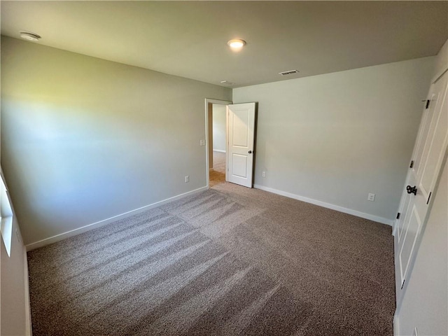 unfurnished bedroom featuring carpet floors, visible vents, and baseboards