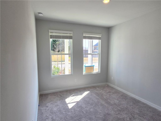 spare room with carpet flooring and baseboards