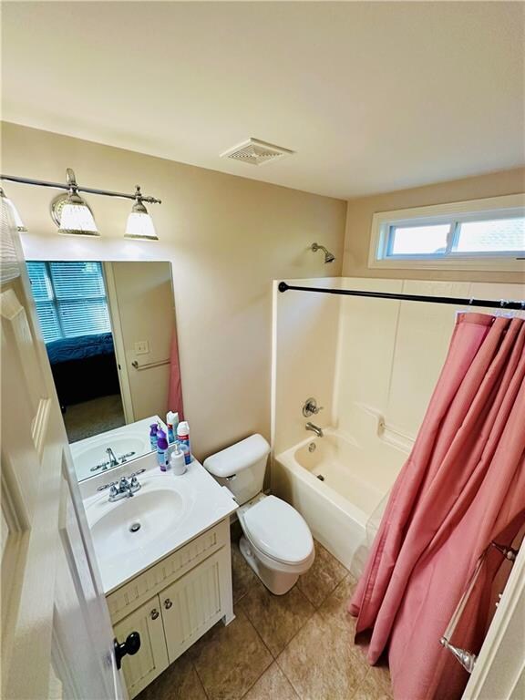 full bathroom with vanity, tile patterned flooring, toilet, and shower / tub combo with curtain