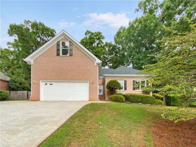 view of property with a garage and a front lawn