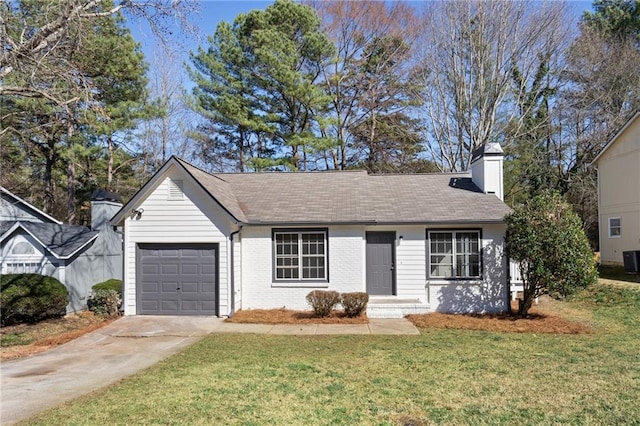 ranch-style home with driveway, a front yard, a garage, brick siding, and a chimney