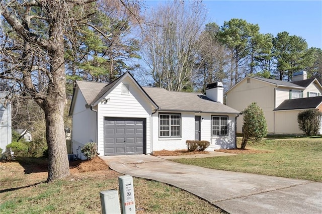 view of front facade featuring brick siding, concrete driveway, a front yard, a chimney, and a garage