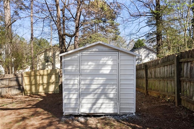 view of shed with a fenced backyard