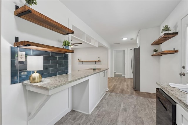 2060 Panstone Ct SW, Marietta, GA 30060 - kitchen with open shelves, black dishwasher, freestanding refrigerator, white cabinets, and light wood-type flooring