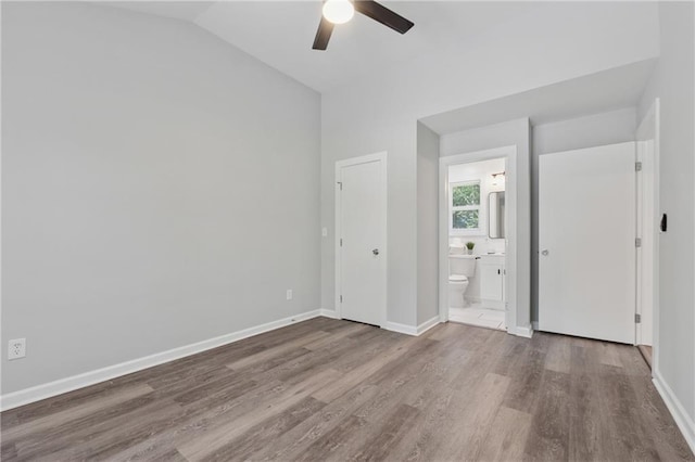 2060 Panstone Ct SW, Marietta, GA 30060 - unfurnished bedroom with wood finished floors, lofted ceiling, baseboards, and ensuite bathroom