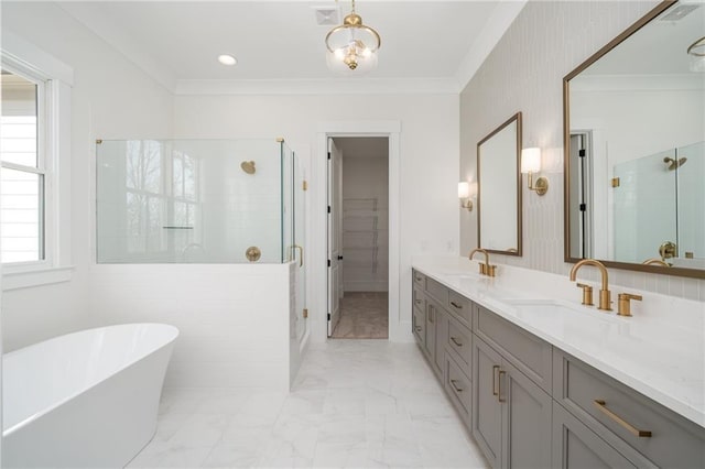 full bathroom with ornamental molding, a stall shower, marble finish floor, and a sink