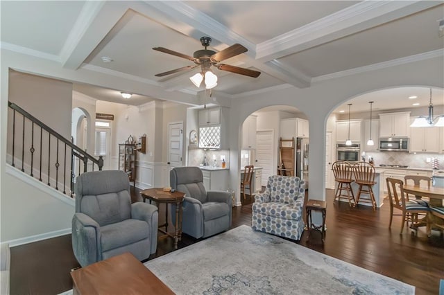 living room with ornamental molding, dark hardwood / wood-style floors, and beam ceiling