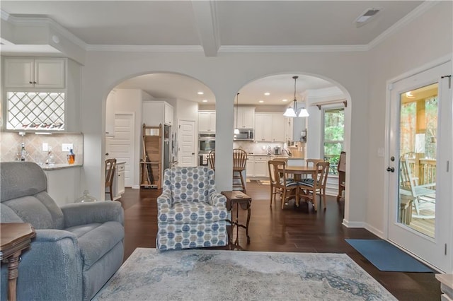 living room with ornamental molding and dark hardwood / wood-style floors