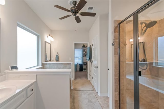 bathroom featuring ceiling fan, vanity, and a shower with shower door