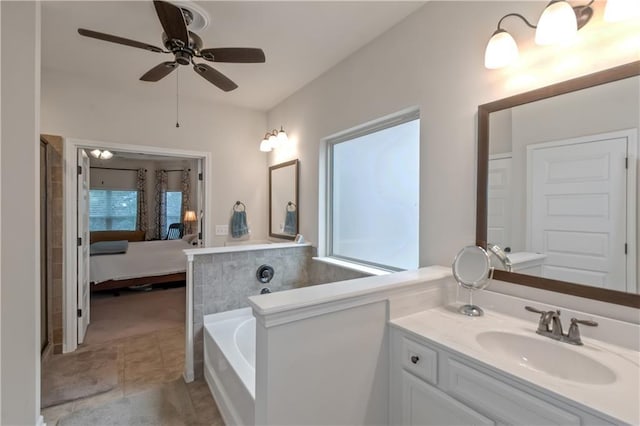 bathroom with vanity, a bath, and ceiling fan