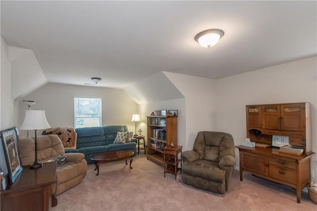 living room with light colored carpet and vaulted ceiling